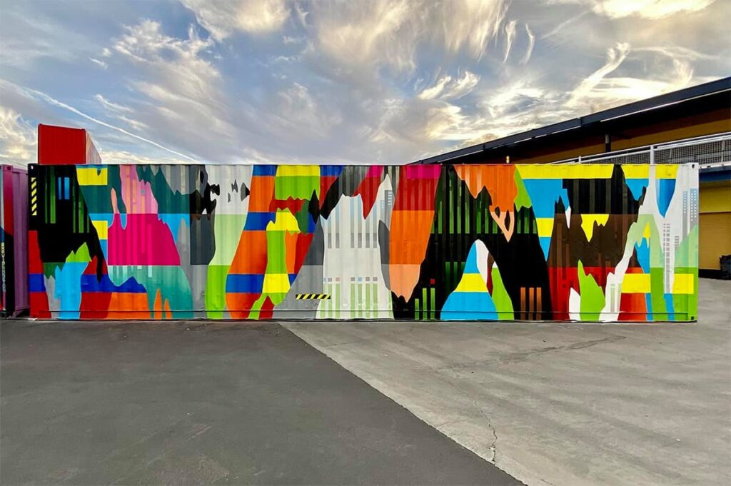 Exterior of a building painted with a colorful geometric mural