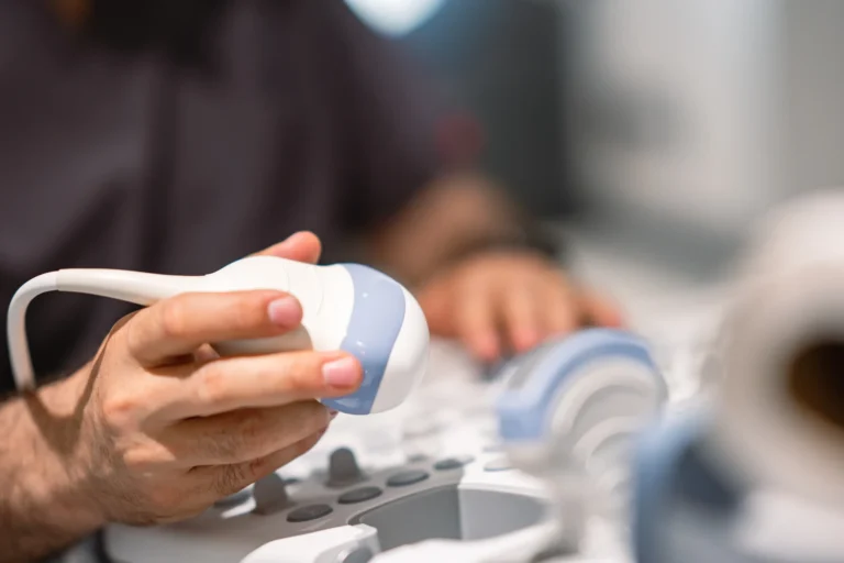 Clinician holding an ultrasound probe during an examination